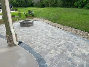 A custom stone patio with a fire pit demonstrates quality paver patios and driveways in Summerdale, AL.