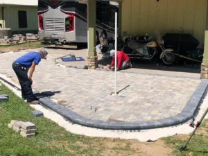 Contractors laying interlocking stone pavers for paver patios and driveways in Summerdale, AL.