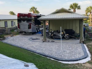 Newly built paver patios and driveways in Summerdale, AL extending around a covered RV pavilion.